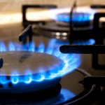 Black gas stove and two burning flames close-up